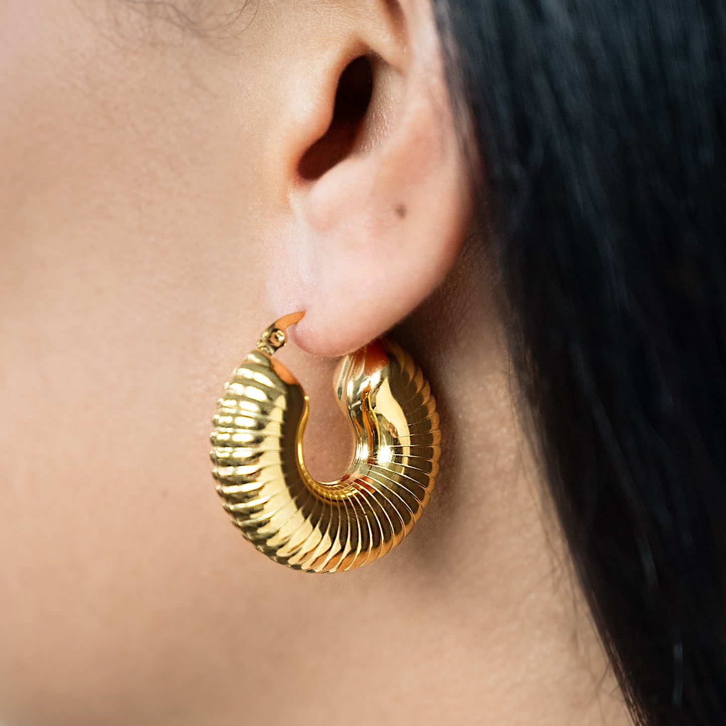 Chunky Shell Hoop Earrings Non Tarnish shown worn in a model's ear