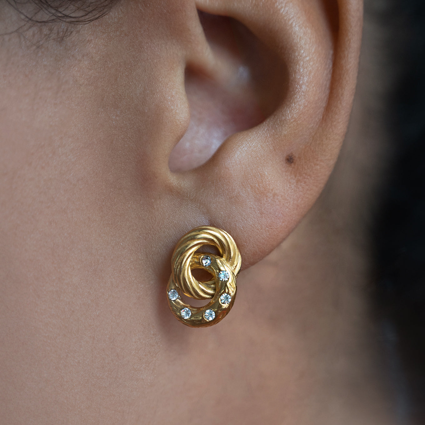 Linked Circles Diamante Stud Earrings Non Tarnish shown worn in a model's ear