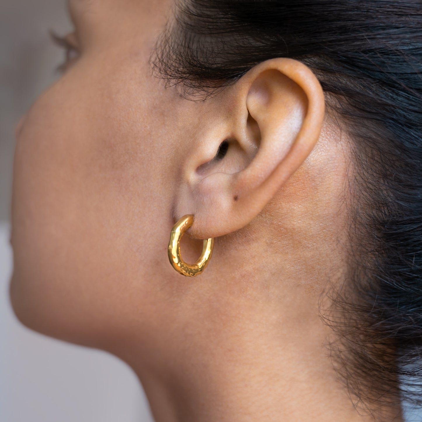 Gold Plated Molten Hoops Non Tarnish shown worn in a model's ear