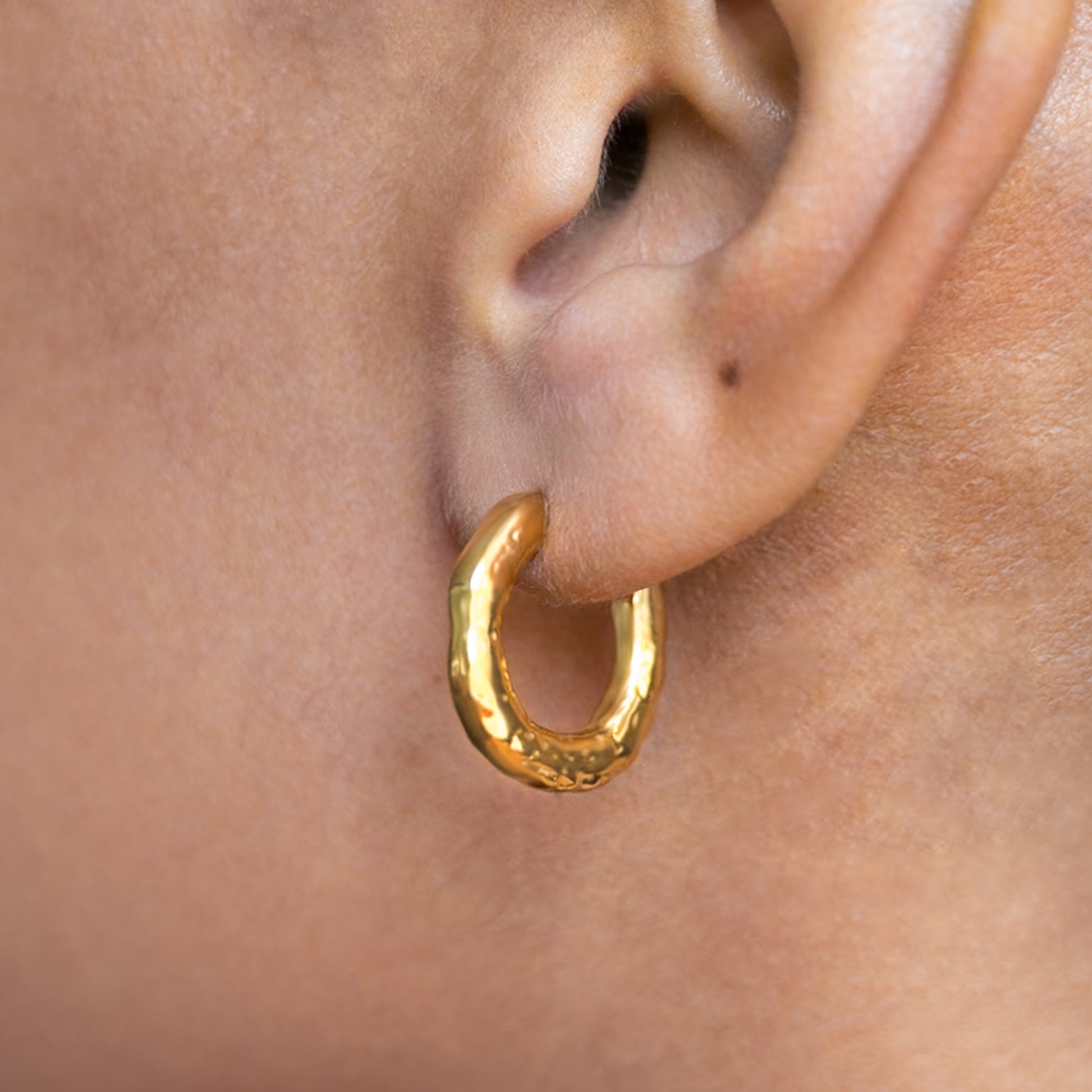 Gold Plated Molten Hoops Non Tarnish shown worn in a model's ear