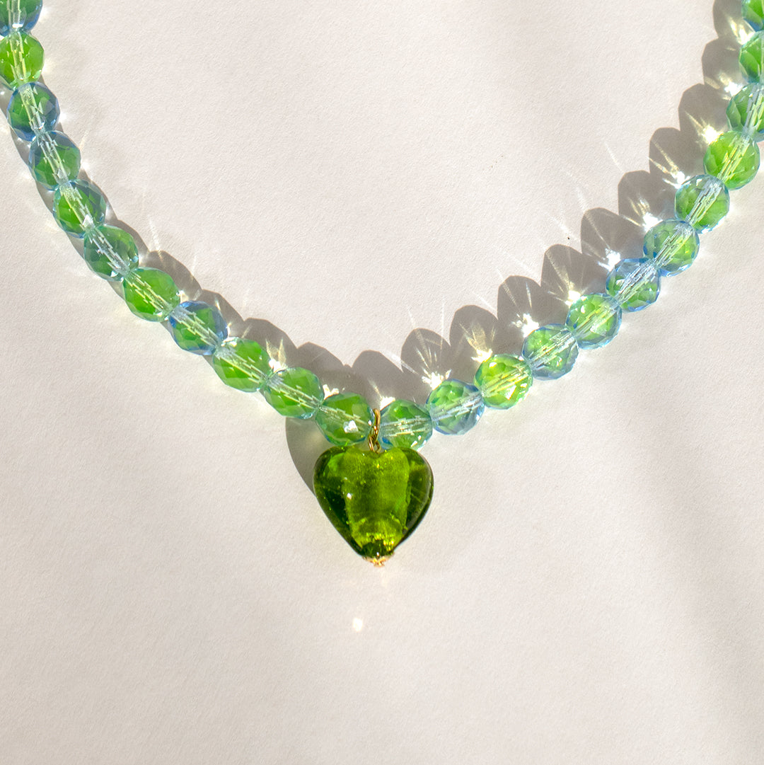 Iridescent Olive Heart Bead Necklace against white background