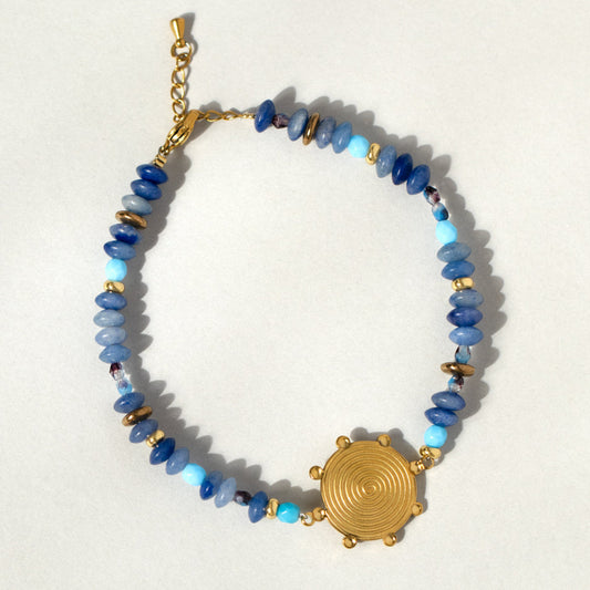 Blue Gemstone Bead And Gold Swirl Bracelet