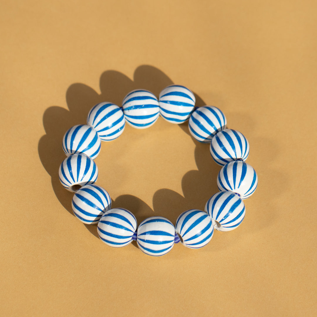 Blue and white striped bracelet on a beige background