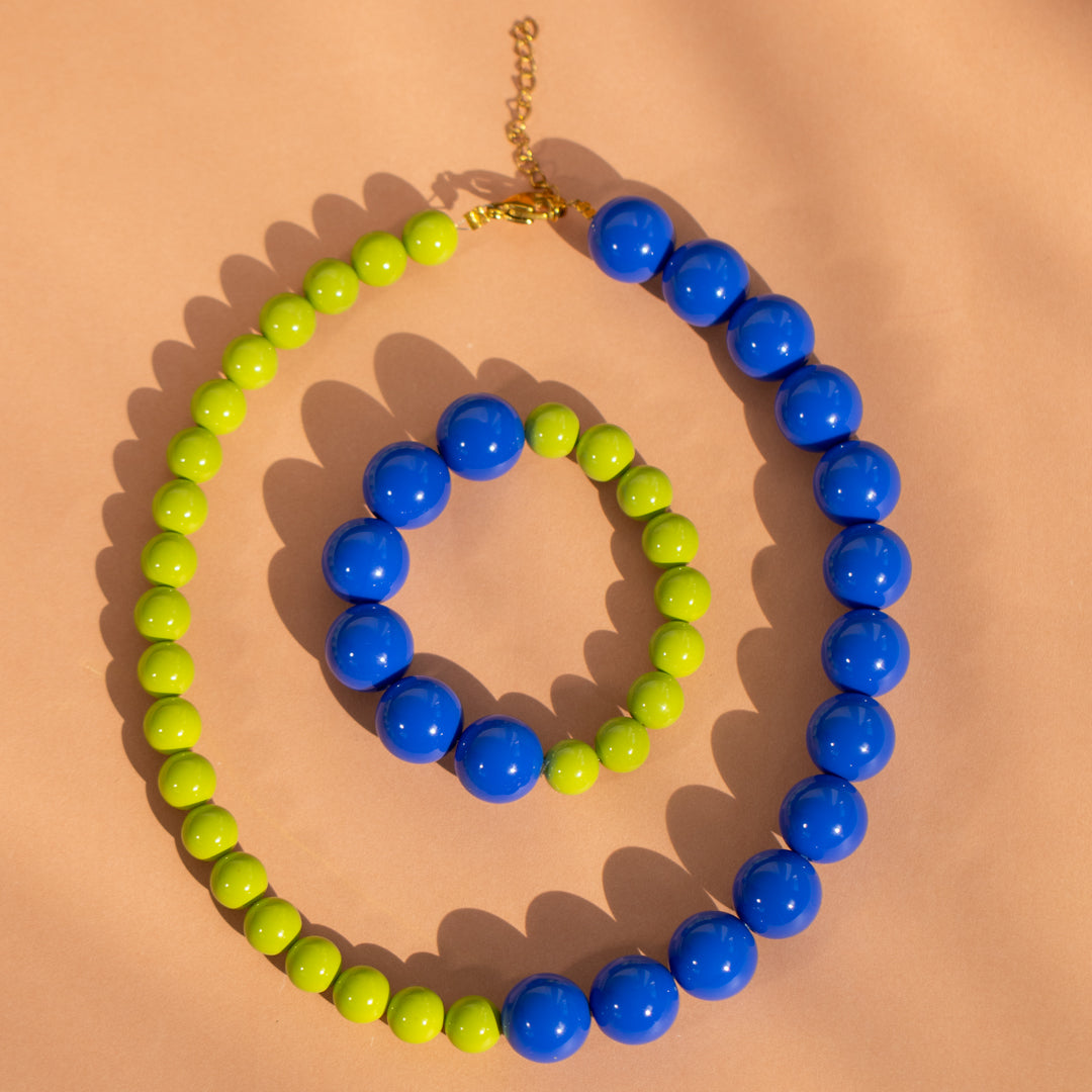 Necklace with blue and green beads on a beige background